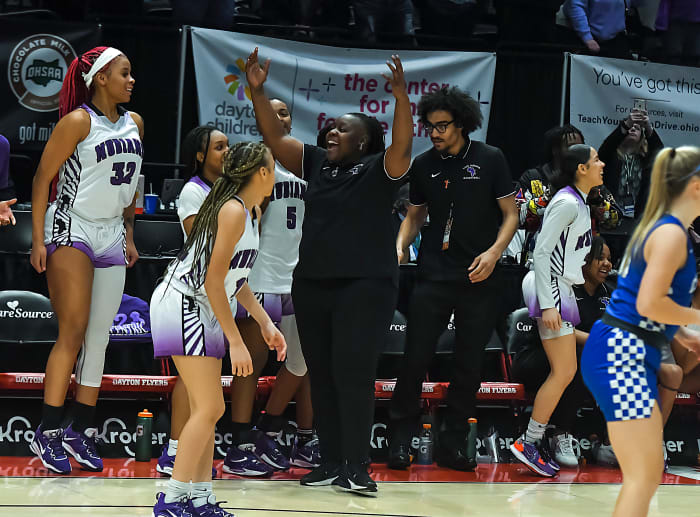 Africentric girls basketball coach Janicia Anderson and her players start to celebrate as time ticks down in the 2023 OHSAA Division III state championship game. Africentric defeated Chippewa 75-62 to claim the state title.
